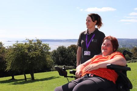 Joanne out in the park over looking swansea bay with client who is enjoying the sunshine