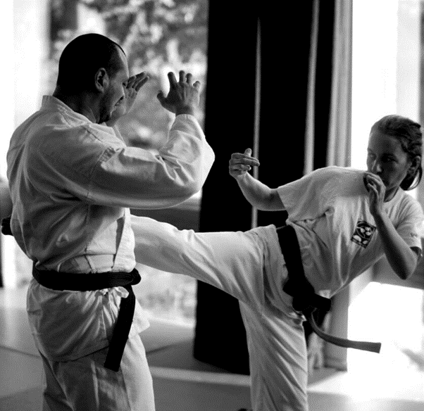 Female-karate-fighter-in-traing-with-her-coach