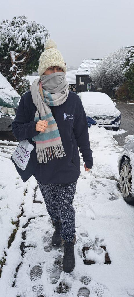 Carer Walking in the snow to a clients home