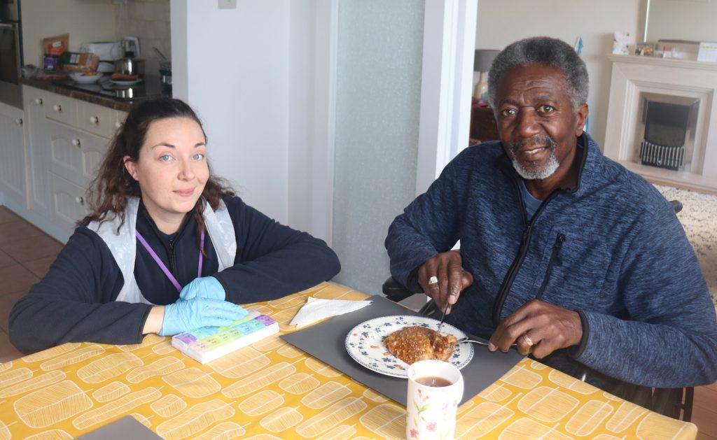 Emma supporting client with his dinner